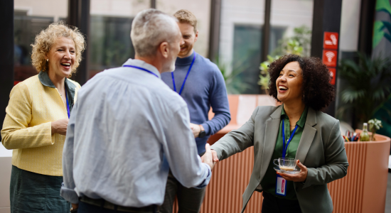 September Spoke Onboarding Webinar; photo of people shaking hands at an event